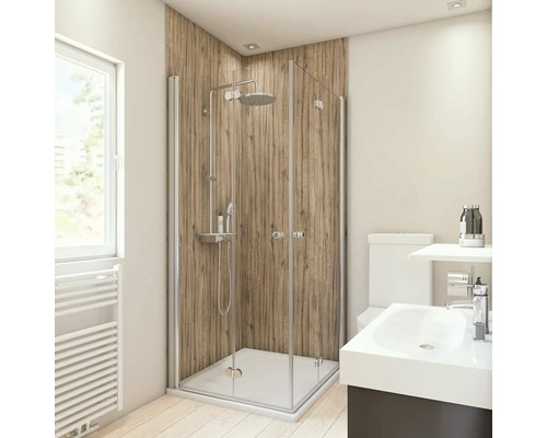 Salle de bain lumineuse avec cabine de douche, lavabo et toilettes