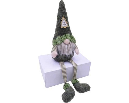Gnome de Noël décoratif vert avec barbe et jambes rayées assis sur une boîte en carton