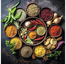 Diverses épices et herbes aromatiques présentées dans des bols sur un fond sombre.