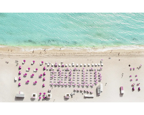 Luftaufnahme eines Strandes mit Liegestühlen und Sonnenschirmen