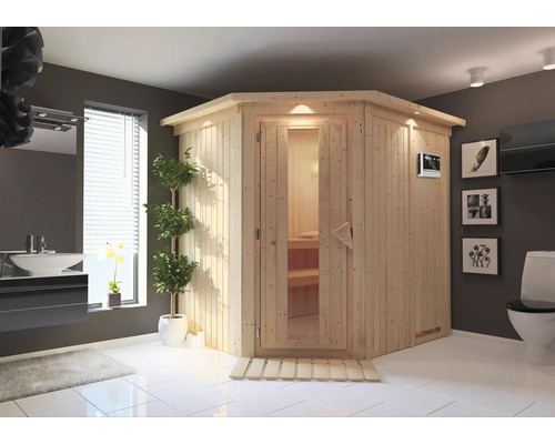 Sauna Plug & Play Karibu Achat VII avec poêle Bio 3,6 kW et commande externe, avec couronne et porte bois en verre isolé thermiquement Sauna claire avec porte en verre dans une salle de bains avec lavabo et toilettes