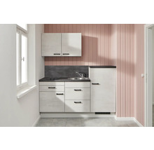 Petite kitchenette avec évier, plaque de cuisson, armoire suspendue et réfrigérateur dans une pièce lumineuse.