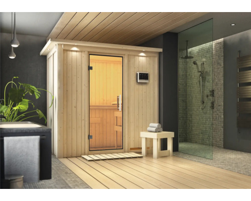 Elementsauna Karibu Mariado inkl. 9 kW Bio Ofen u.ext.Steuerung mit Dachkranz und Ganzglastüre aus Klarglas Moderne Sauna mit Holzausstattung und Glasdusche in einem Badezimmer.