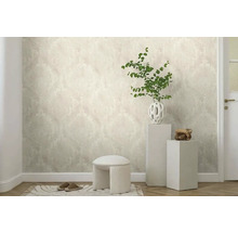 Dekoratives Zimmer mit gemusterter Tapete, Hocker, Pflanzen und Wohnaccessoires