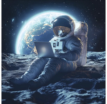 Un astronaute est assis sur la lune et utilise un ordinateur portable.