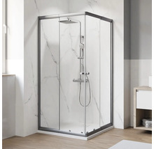 Douche d'angle avec robinetterie dans une salle de bain lumineuse