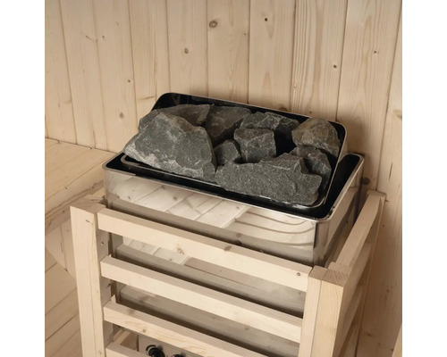 Poêle de sauna avec pierres de sauna dans une cabine en bois