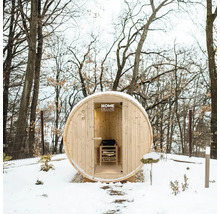 Sauna en tonneau en bois dans un jardin hivernal