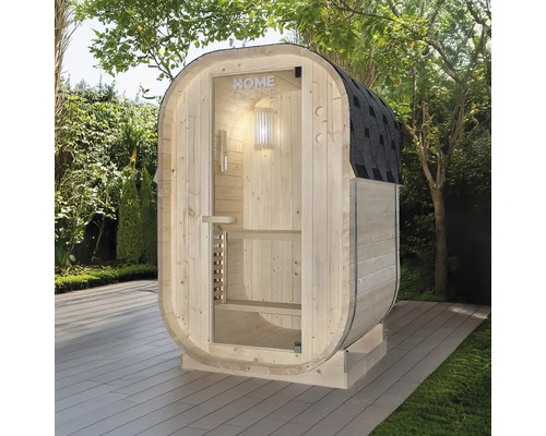 Sauna en bois avec porte en verre et carton bitumé dans le jardin.