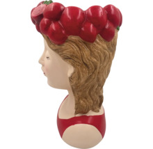 Pot de fleurs en forme de tête de femme avec des fraises comme accessoires pour cheveux