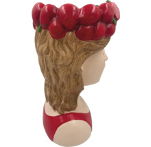 Pot de fleurs en forme de tête de jeune fille avec une couronne de fleurs de cerisier