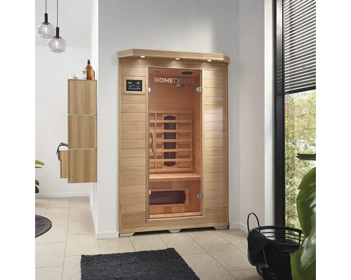 Sauna infrarouge en bois avec porte en verre et panneau de commande numérique dans une pièce lumineuse