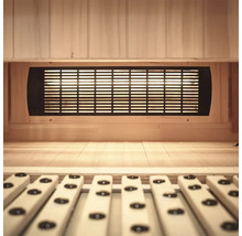 Intérieur d'un sauna avec lambris en bois et grille de ventilation