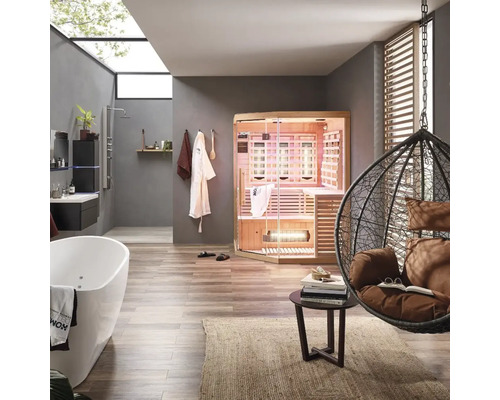 Salle de bains avec baignoire, douche, sauna infrarouge et fauteuil suspendu dans un design clair et convivial