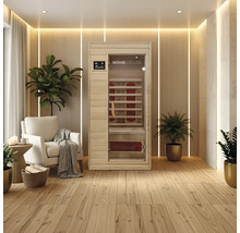 Sauna infrarouge dans une pièce claire et moderne avec plancher en bois et plantes