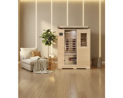 Sauna infrarouge avec banc et radiateurs infrarouges dans une pièce lumineuse avec plancher en bois