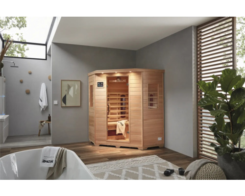 Sauna infrarouge d'angle en bois dans une salle de bains avec baignoire