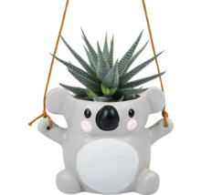 Pot de fleurs suspendu en forme de koala avec plante succulente