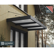 Canopia by Palram Türvordach in Dunkelgrau mit lichtdurchlässigen Platten und Hitzeschutz-Technologie, montiert an einer Fassade.