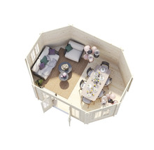 Vue intérieure d'un pavillon de jardin avec coin salon et table à manger