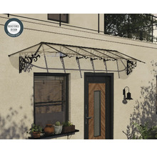 Transparentes Pultvordach mit schwarzen verzierten Metallkonsolen über einer Haustür und einem Fenster montiert, eingetragenes Design.