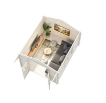 Vue intérieure d'un abri de jardin avec coin salon, comprenant un canapé, une table et une télévision