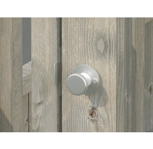 Bouton rotatif en métal sur une porte en bois