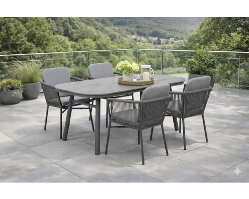 Ensemble de jardin avec table à manger et chaises sur une terrasse donnant sur un environnement boisé.