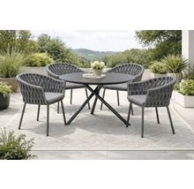 Ensemble de meubles de jardin avec table ronde et quatre chaises sur un tapis à l'extérieur.