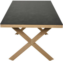 Table à manger moderne avec plateau sombre aspect pierre et piètement en X en bois.