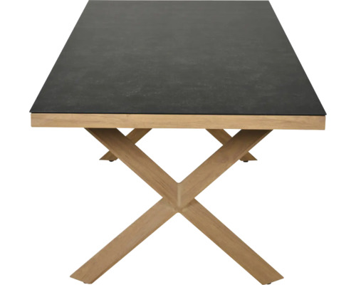 Table à manger moderne avec plateau sombre aspect pierre et piètement en X en bois.