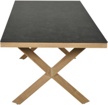Table rectangulaire avec plateau foncé aspect pierre et piètement en X en bois clair.