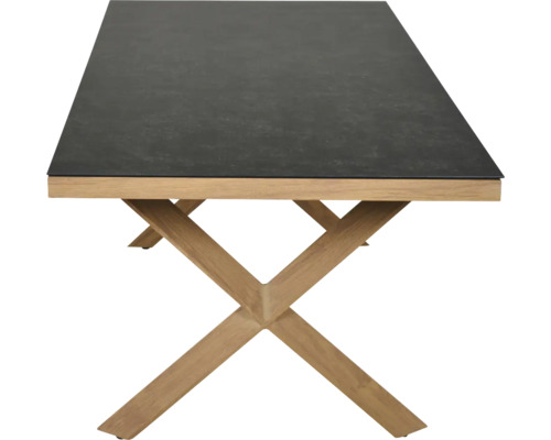 Table rectangulaire avec plateau foncé aspect pierre et piètement en X en bois clair.