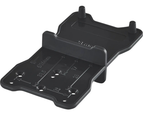 Schwarze Bohrschablone und Markierungshilfe aus Kunststoff für die Möbelmontage mit Millimeter-Maßangaben.