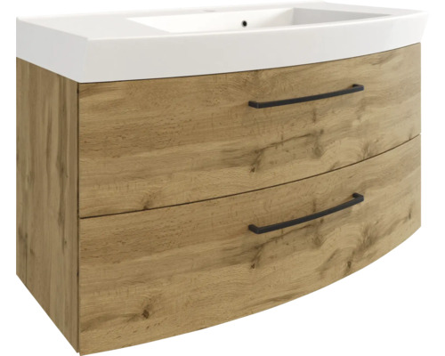Waschbeckenunterschrank mit Waschbecken, Eiche-Optik, zwei Schubladen mit schwarzen Griffen und geschwungener Front.