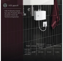 Elektrischer Durchlauferhitzer von AEG an einer dunklen Wand, geprüft vom VDE-Prüfinstitut