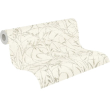 Papier peint intissé partiellement déroulé avec motif de graminées délicat.