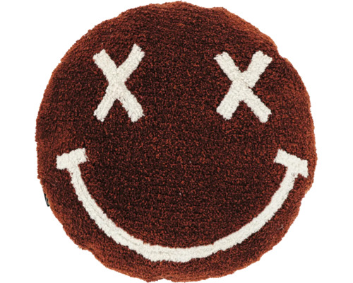 Rundes braunes Dekokissen aus flauschigem Stoff mit einem weißen Smiley-Gesicht aus Kreuzen als Augen und einem lächelnden Mund.