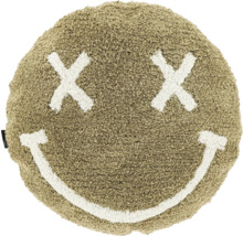 Rundes, flauschiges Kissen in Sandfarben mit einem Smiley-Gesicht aus zwei Kreuzen als Augen und einem lächelnden Mund.