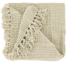 Plaid beige avec tissage gaufré et franges.