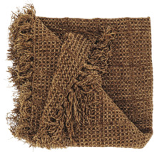 Couverture avec structure gaufrée et franges en marron.