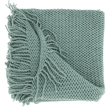 Plaid vert en maille épaisse avec franges décoratives.