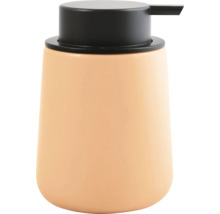 Distributeur de savon en céramique de couleur pêche avec pompe noire pour la salle de bain.