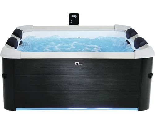 Whirlpool MSpa avec habillage aspect bois, eau bouillonnante, appuie-têtes et écran numérique affichant 38 degrés.