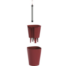 Système d'arrosage Lechuza en trois parties avec indicateur de niveau d'eau, bac d'arrosage à mèche et un pot de fleurs rouge.