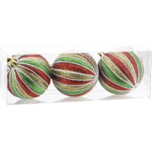 Trois boules de Noël avec un motif de rayures pailletées rouges, vertes et dorées dans une boîte.