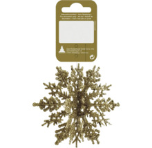 Flocon de neige scintillant doré comme décoration de Noël sur un support en carton.