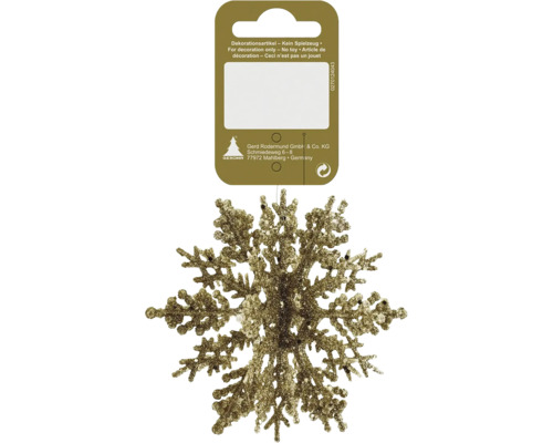 Flocon de neige scintillant doré comme décoration de Noël sur un support en carton.