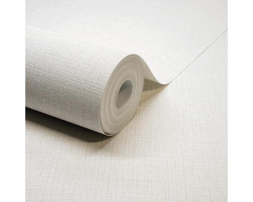 Papier peint texturé avec un aspect lin, rouleau de papier peint partiellement déroulé.