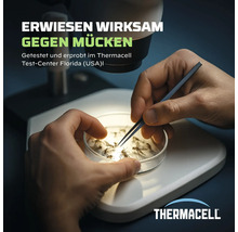 Hände untersuchen Mücken in einer Petrischale unter einem Mikroskop im Thermacell Testzentrum. Erwiesen wirksam gegen Mücken.